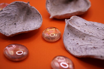 White potpourri on an orange background with matching glass marbles