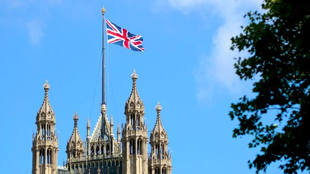 The footage of Parliament Tower and flying Union Jack in London on a summer day