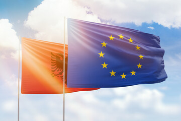 Sunny blue sky and flags of european union and albania - obrazy, fototapety, plakaty