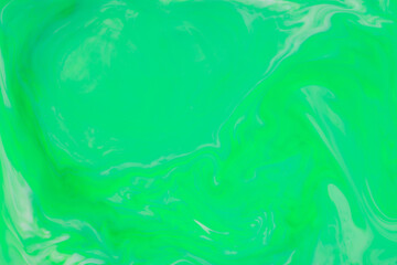 Green Fluid Art Background. Abstract liquid trendy backdrop. Different shades of green on a blurry surface