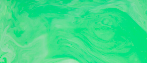 Green Fluid Art Background. Abstract liquid trendy backdrop. Different shades of green on a blurry surface