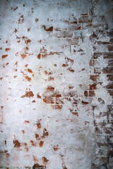 Dilapidated building facade with damaged plaster.