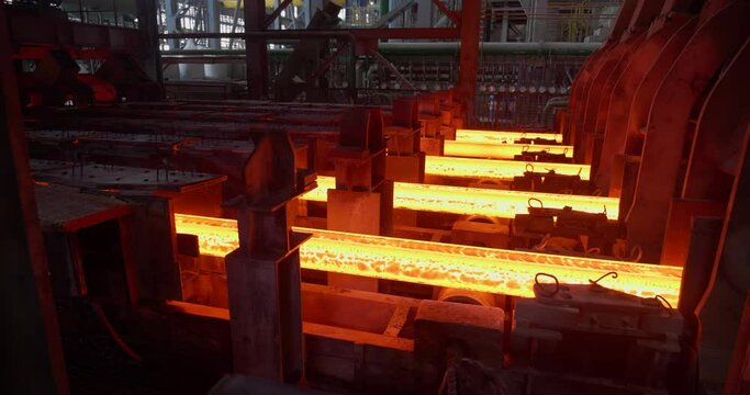 Iron foundry. Continuous casting machine. Production of steel billets. Steel billet moving through the pipeline. Business concept, modern steel production technology