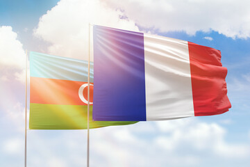 Sunny blue sky and flags of france and azerbaijan