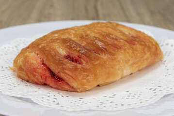 Tempting fresh from the oven chocolate croissant from the bakery served on a plate