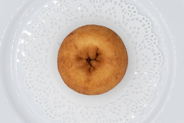 Overhead view of tempting fresh from the oven plain donut from the bakery served on a plate