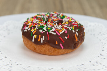 Tempting fresh from the oven sprinked cake donut from the bakery served on a plate