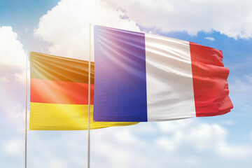 Sunny blue sky and flags of france and germany