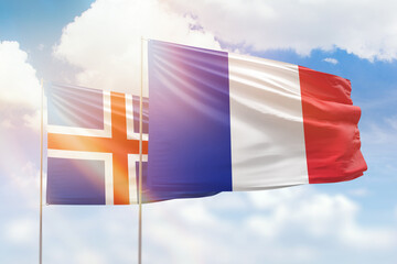 Sunny blue sky and flags of france and iceland