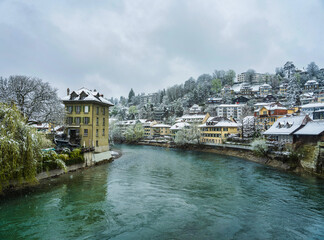 Fototapeta premium Swiss city of Bern in river Aare during snowfall in Bern Switzerland