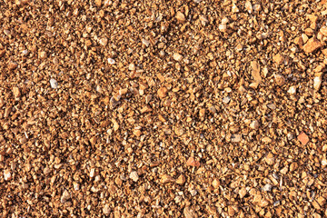 small crushed stones on red earth. background