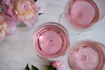 Rose wine, peony flower on a light background
