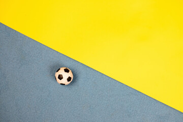 soccer ball on a blue-yellow background