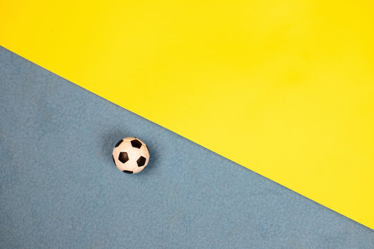 soccer ball on a blue-yellow background