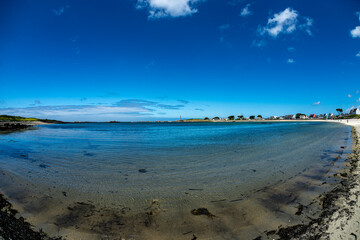 Breton shore at low tide with an ultra-wide-angle lens. View of a portion of shoreline in Brittany at a place called Lilia-Plouguerneau France June 2022.