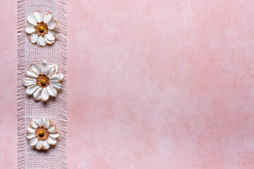 peach textured background with white burlap ribbon and 3 flower left border