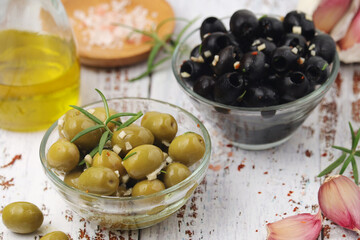 Black and green olives in glass bowls