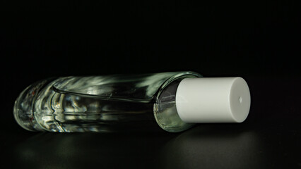 bottle of perfume on black background 