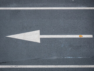White Arrow Symbol in a Straight Direction on an Asphalted Avenue