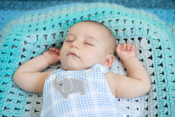 postcard of beautiful baby sleeping on blue fleece blanket