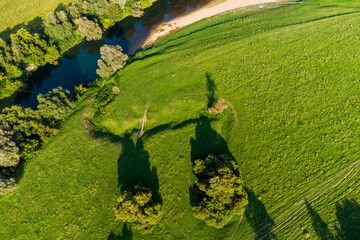 Beautiful green landscape of a river valley with fields and ravines from the air, flat landscape