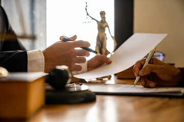 Attorneys or lawyers who are reading the statute of limitations Consultation between male lawyers and business clients, tax and legal and legal services firms. - obrazy, fototapety, plakaty