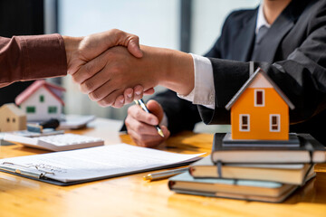 Successful deal Real estate lease or home purchase concept buyer shakes hands with bank employee...