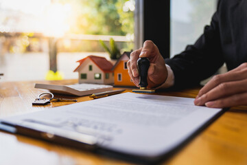 Real estate agents stamp their approval to buy and sell homes. with insurance for customers
