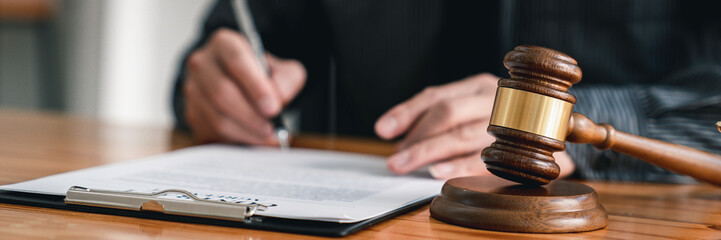 Lawyer man holding pen with contract or agreement document to the customer for signing in courtroom...