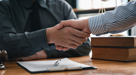 Lawyers shake hands with business people to seal a deal with partner lawyers. or a lawyer...