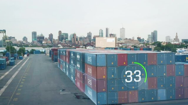 Augmented reality in logistics showing figures about stacked naval containers in cargo terminal. High rise buildings in background. New York City, USA