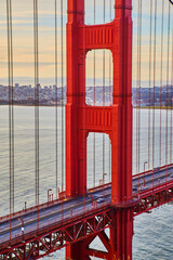 Morning traffic crossing vibrant red Golden Gate Bridge in San Francisco