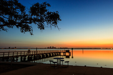 Fototapeta na wymiar Morning Sunrise, dock forground, Tampa Background