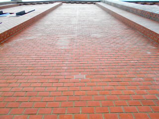 looking up at a red bricks wall 