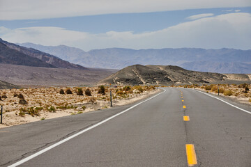 Road through Death Valley surrounded by sandy desert