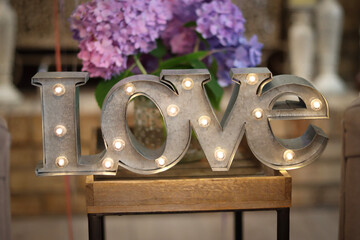 bouquet of flowers with Love sign in foreground 
