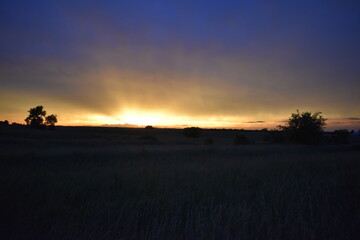Sunset Over a Rural Farm Field