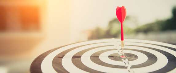 Bullseye or Bulls eye target or dartboard has dart arrow throw hitting the center of a shooting for financial business targeting planning and aim to winner goal of business concept.
