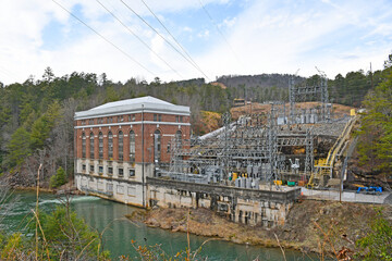 Fototapeta na wymiar Old hydro electric brick power plant on the river in a forest in north Georgia 