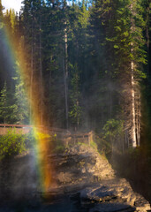 Athabasca Falls in Jasper, Alberta with Rainbow.  Mountains and beauty.