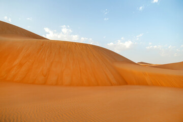 Natural landscape of the orange color sand dunes in the desert in Abu Dhabi