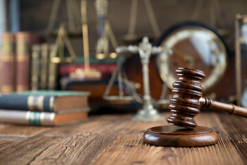 Lawyer office. Gavel and legal books on the judge rustic wooden desk.