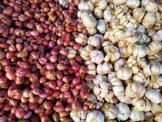 top view of split raw onion and garlic in Indonesian traditional market. Asian market trade
