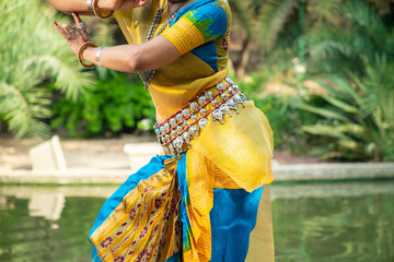 Closeup of Indian woman Odissi dancer doing classical dance form outdoor at nature park. Orissi...