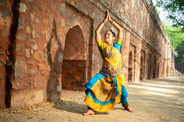 Indian woman Odissi dancer doing classical dance form outdoor,  art and culture of india.