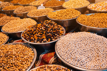 Roasted chickpeas, dried fruits and other nuts on the farmers counter at the local market or...