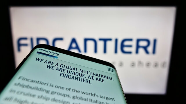 Stuttgart, Germany - 02-26-2022: Smartphone with webpage of Italian shipbuilding company Fincantieri SpA on screen in front of business logo. Focus on top-left of phone display.