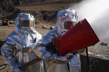 Almaty, Kazakhstan - 09.22.2021 : Rescuers in special protective suits extinguish the plane in...