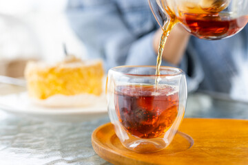 Pouring hot tea at outdoor cafe