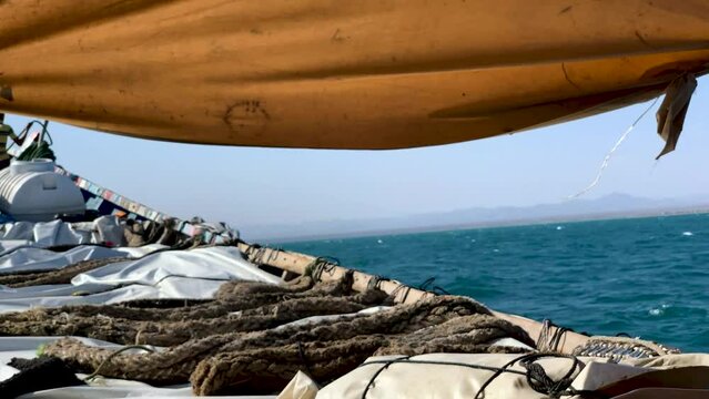 Wooden boat meant for goods getting closer to the shore of Ras Alara - Lahj Yemen.